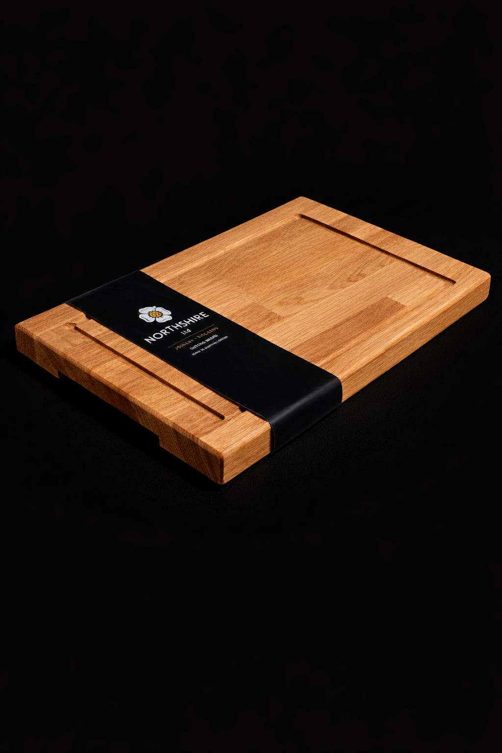 Northshire oak cutting board with juice grooves and branded sleeve