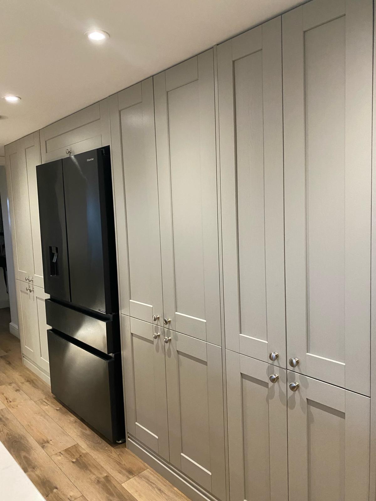 Neutral kitchen pantry cabinets with black fridge freezer