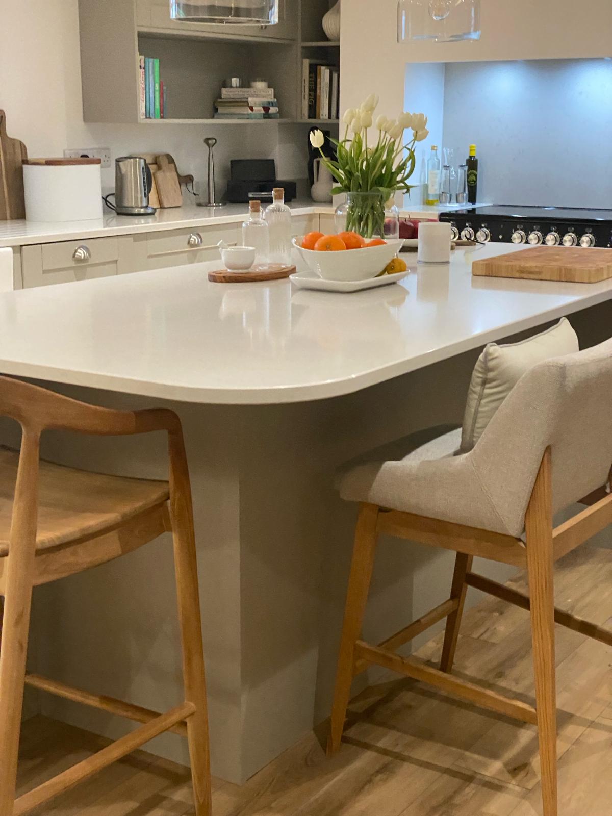 Neutral kitchen island with flowers and chopping board